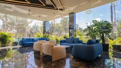 a lobby with blue and white furniture and plants at The Two Umalass in Canggu