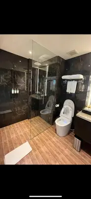 a bathroom with two toilets and a glass wall at The Two Umalass in Canggu