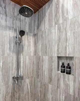 a shower in a bathroom with a stone wall at Villa Marsin Umalas - 10 Minutes to Finns Beach Club in Seminyak
