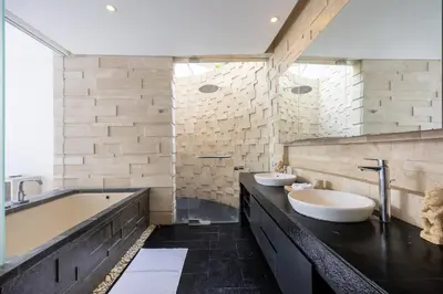 a bathroom with two sinks and a bath tub at Modern 2BR Villa with Private Pool Prime Location in Seminyak