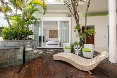 a living room with a couch and a fireplace at Modern 2BR Villa with Private Pool Prime Location in Seminyak