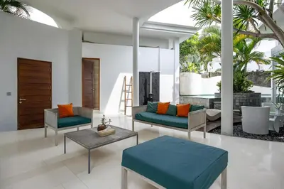 a living room with two chairs and a table at Modern 2BR Villa with Private Pool Prime Location in Seminyak