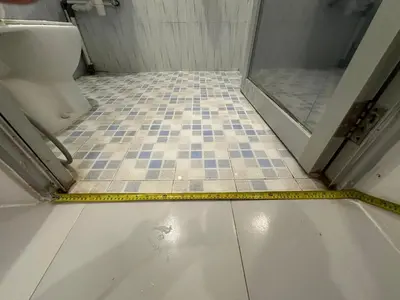 a yellow measuring tape on a bathroom floor with a toilet at Rumah Jimbaran Kuta 2 bedroom 6 pax SukaBali 2 in Jimbaran