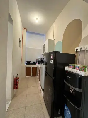 a small kitchen with a black refrigerator in a room at Rumah Jimbaran Kuta 2 bedroom 6 pax SukaBali 2 in Jimbaran