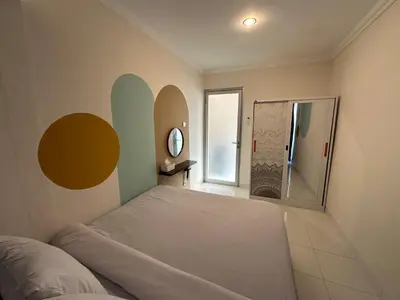 a bedroom with a bed and a large window at Rumah Jimbaran Kuta 2 bedroom 6 pax SukaBali 2 in Jimbaran