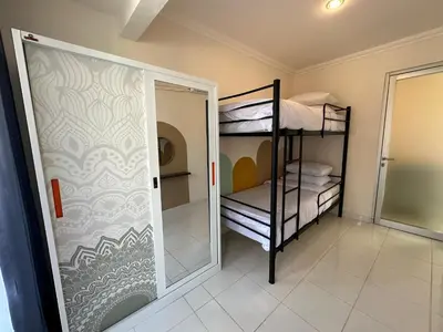 a room with two bunk beds and a mirror at Rumah Jimbaran Kuta 2 bedroom 6 pax SukaBali 2 in Jimbaran