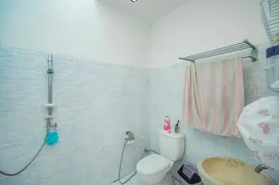 a bathroom with a toilet and a sink and a shower at villa putih in Seminyak