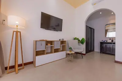 a living room with a television on the wall at Villa Phoenix Brand New 1BR in Umalas, Bali in Seminyak
