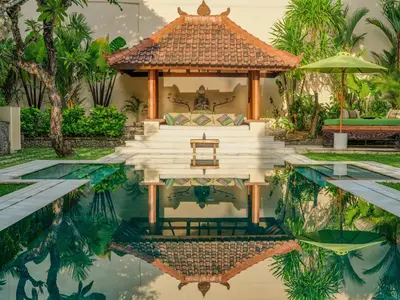 a villa with a pool and a house at Villa Mata Budha Seminyak in Seminyak