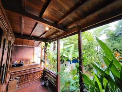 a balcony of a house with a large garden at 2BR Abelle garden lumbung house in Kerobokan