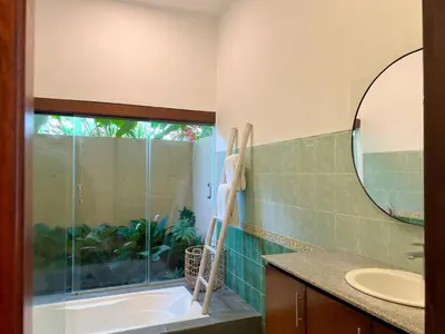 a bathroom with a tub and a sink and a mirror at 4bedroom - Kamaya Villa in center of Seminyak in Seminyak