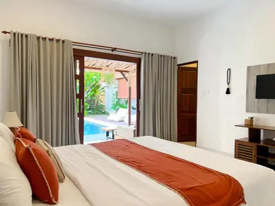 a bedroom with a bed and a sliding glass door at 4bedroom - Kamaya Villa in center of Seminyak in Seminyak