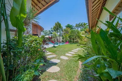 a garden path leading to a swimming pool at Villa Lea Luxury Oasis in Seminyak Umalas with private pool 4BR in Seminyak