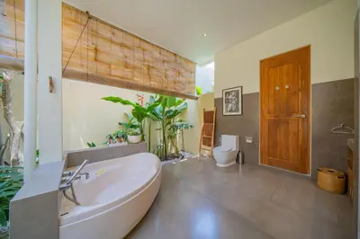 a bathroom with a large tub and a toilet at Villa Lea Luxury Oasis in Seminyak Umalas with private pool 4BR in Seminyak