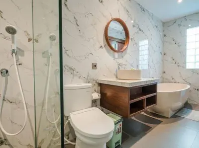 a bathroom with a toilet and a shower and a sink at Metta Villa in Jimbaran