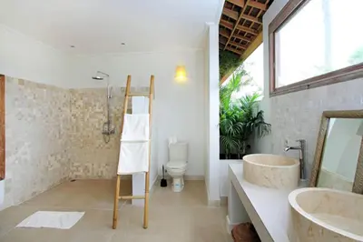 a bathroom with a sink and a toilet and a ladder at Villa Varuna in Legian