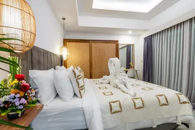a hotel room with a bed with a bunny on it at Villa Arbolita by JB Villas in Seminyak