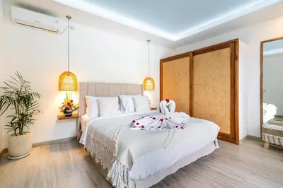 a bedroom with two beds in a room at Villa Arbolita by JB Villas in Seminyak