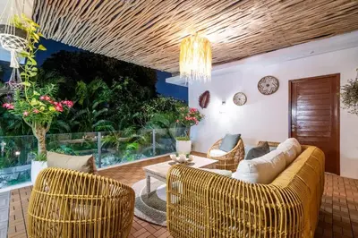 a living room with a couch and chairs and a table at Villa Arbolita by JB Villas in Seminyak