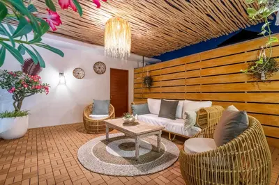 a living room with a couch and chairs and a table at Villa Arbolita by JB Villas in Seminyak