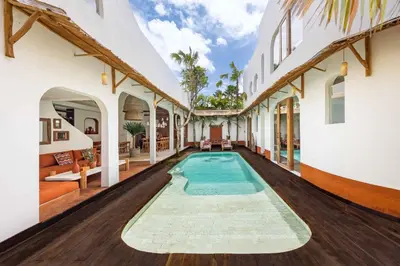 a swimming pool in the middle of a house at Villa Galanga - Brand New Ethnic Hacienda Villa Next to Canggu with Private Pool and Parking in Kerobokan