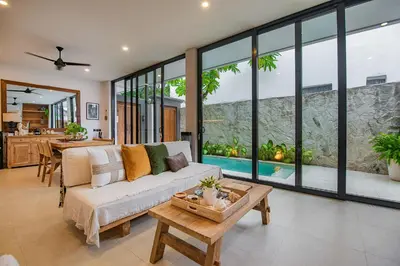 a living room with a couch and a table at Sister Suites in Seminyak