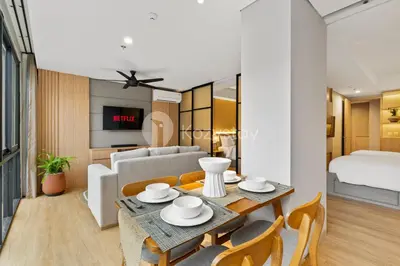 a living room with a table and a couch at Olaia by Kozystay - Nusa Dua in Nusa Dua