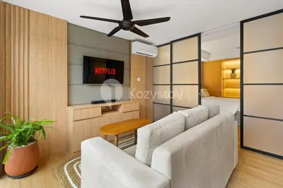 a living room with a couch and a ceiling fan at Olaia by Kozystay - Nusa Dua in Nusa Dua