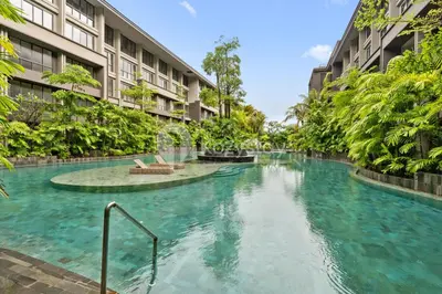 a swimming pool in the middle of a building at Olaia by Kozystay - Nusa Dua in Nusa Dua