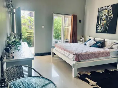 a bedroom with a large bed with a statue on the wall at Gladstudio BrandNew in Kerobokan