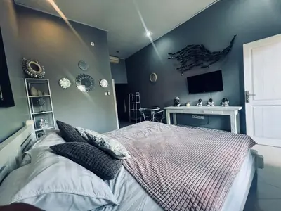 a bedroom with a bed and a tv on the wall at Gladstudio BrandNew in Kerobokan