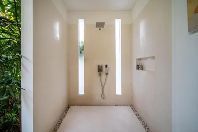 a bathroom with a phone on the wall at Villa Minha Gente Seminyak in Seminyak