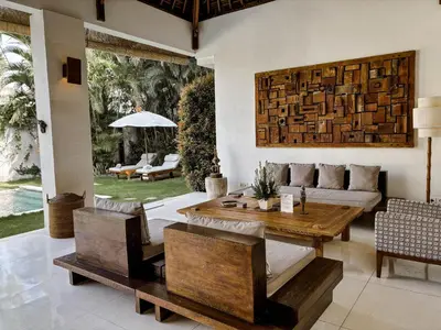a living room with a table and a couch at Villa Chocolat Seminyak 2 Bedroom in Seminyak