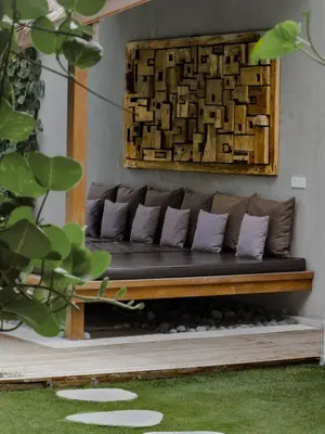 a couch sitting in a living room next to a wall at Villa Chocolat Seminyak 6 Bedroom in Seminyak