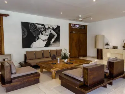 a living room with a couch and a table at Villa Chocolat Seminyak 6 Bedroom in Seminyak