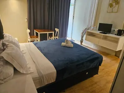 a bedroom with a bed with a towel on it at Two Brothers Guesthouse in Legian