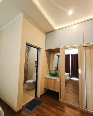 a bathroom with a toilet and a sink at Room Hangtuah Sanur in Kuta