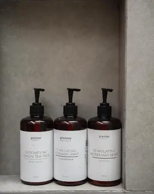 three bottles of soap sitting in a box at The Mango Villa Jimbaran Jimbaran in Jimbaran