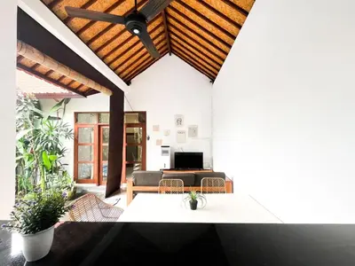 a living room with a couch and a ceiling at Villa Sayang 2 in Seminyak