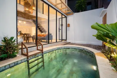 a swimming pool in the middle of a house at Villa Casa Goya - Lofty Pool Villa Near The Beach in Vibrant Legian in Legian