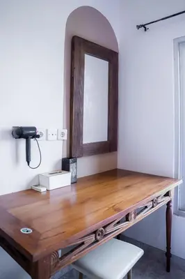 a wooden desk with a mirror on a wall at Rumah Jimbaran Kuta 2 bedroom 6 pax SukaBali 5 in Jimbaran