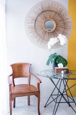 a chair and a glass table with a mirror at Rumah Jimbaran Kuta 2 bedroom 6 pax SukaBali 5 in Jimbaran