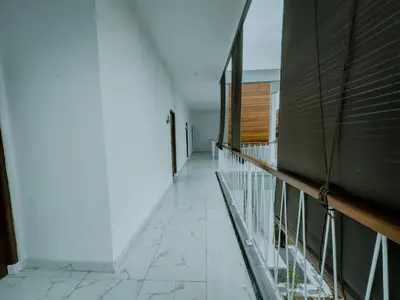 a balcony with a glass railing on a building at Pachira Living Legian in Legian