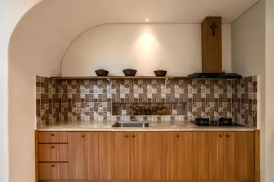 a kitchen with a sink and a counter top at Villa Umabell Villa Seminyak in Seminyak