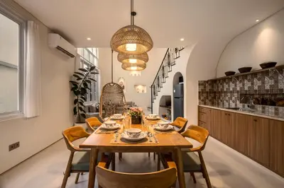 a dining room with a wooden table and chairs at Villa Umabell Villa Seminyak in Seminyak