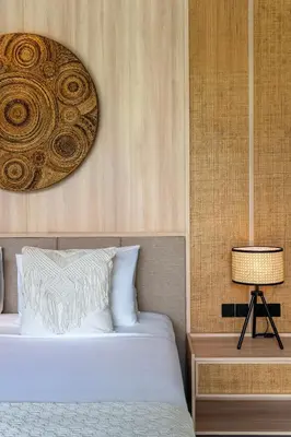 a bedroom with a bed and a table with a lamp at Deneva Villa by Betterplace in Canggu