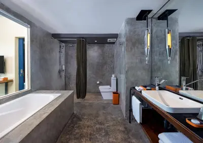 a bathroom with two sinks and a tub and a toilet at Viva Dash Hotel Seminyak in Seminyak