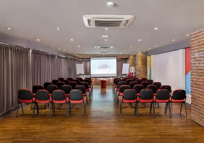 a conference room with chairs and a projection screen at Viva Dash Hotel Seminyak in Seminyak