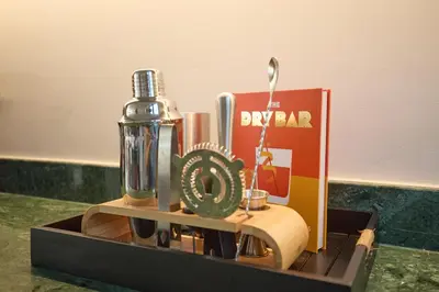 a wooden box with a bottle and a clock on it at Fale Seminyak - Brand New Modern Luxury 5BR Villa in Seminyak with Private Pool, Gym & Massage Room in Seminyak