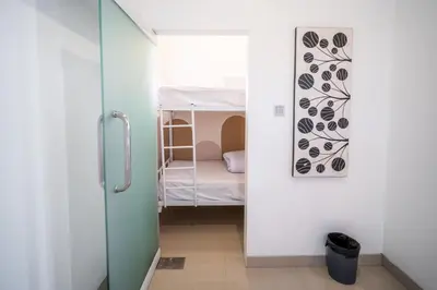 a small room with a bunk bed and a small bedroom at House Jimbaran Kuta 3 bedroom 8 pax SukaBali 6 in Jimbaran